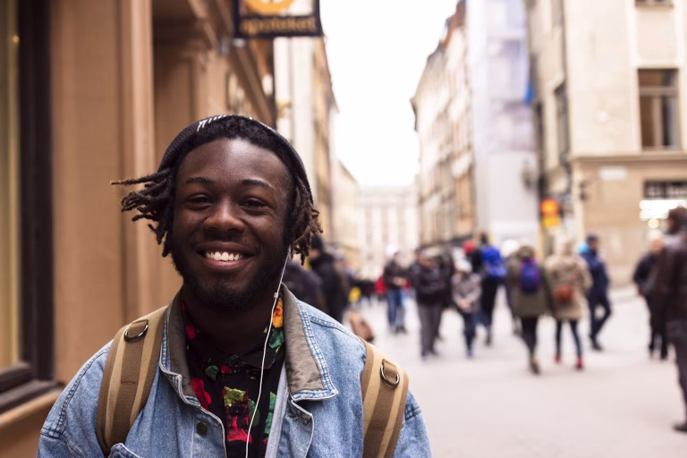 black man smiling and traveling