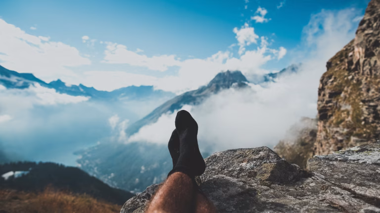 black man solo traveling with feet up
